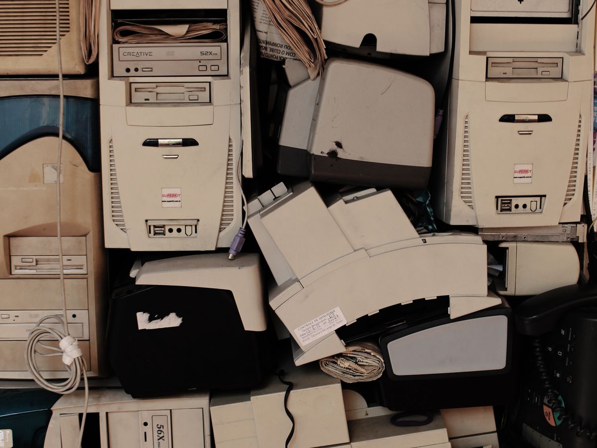Stacks of retired desktop computers awaiting processing