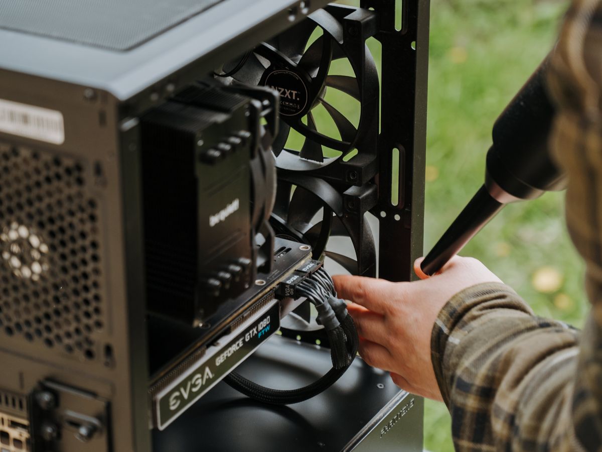 Technician working inside a desktop computer